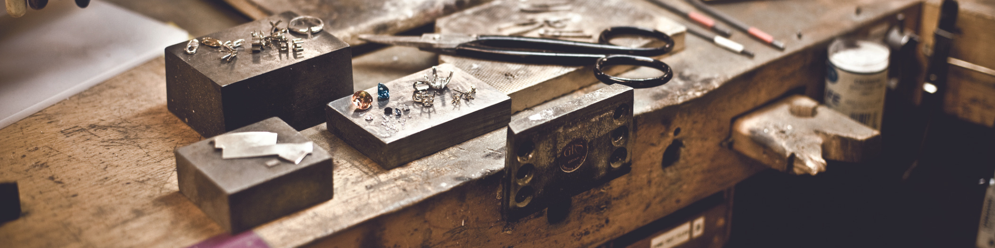 a jeweler's bench with unfinished jewelry