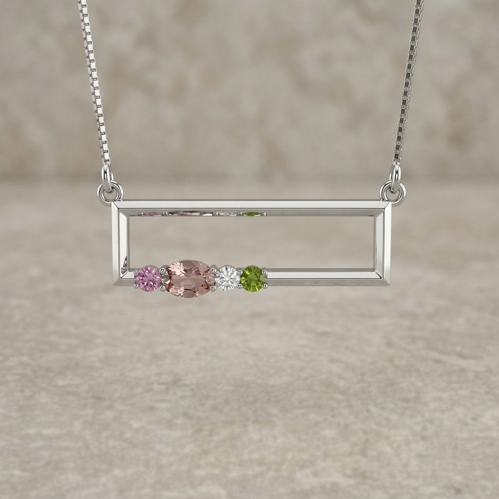 Silver necklace with a rectangular pendant featuring three colored stones on a beige background