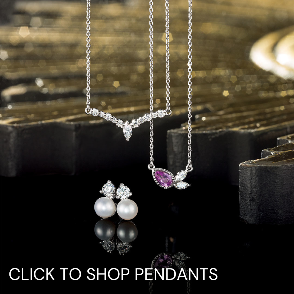 Pendants hanging against a dark background captioned click to shop pendants