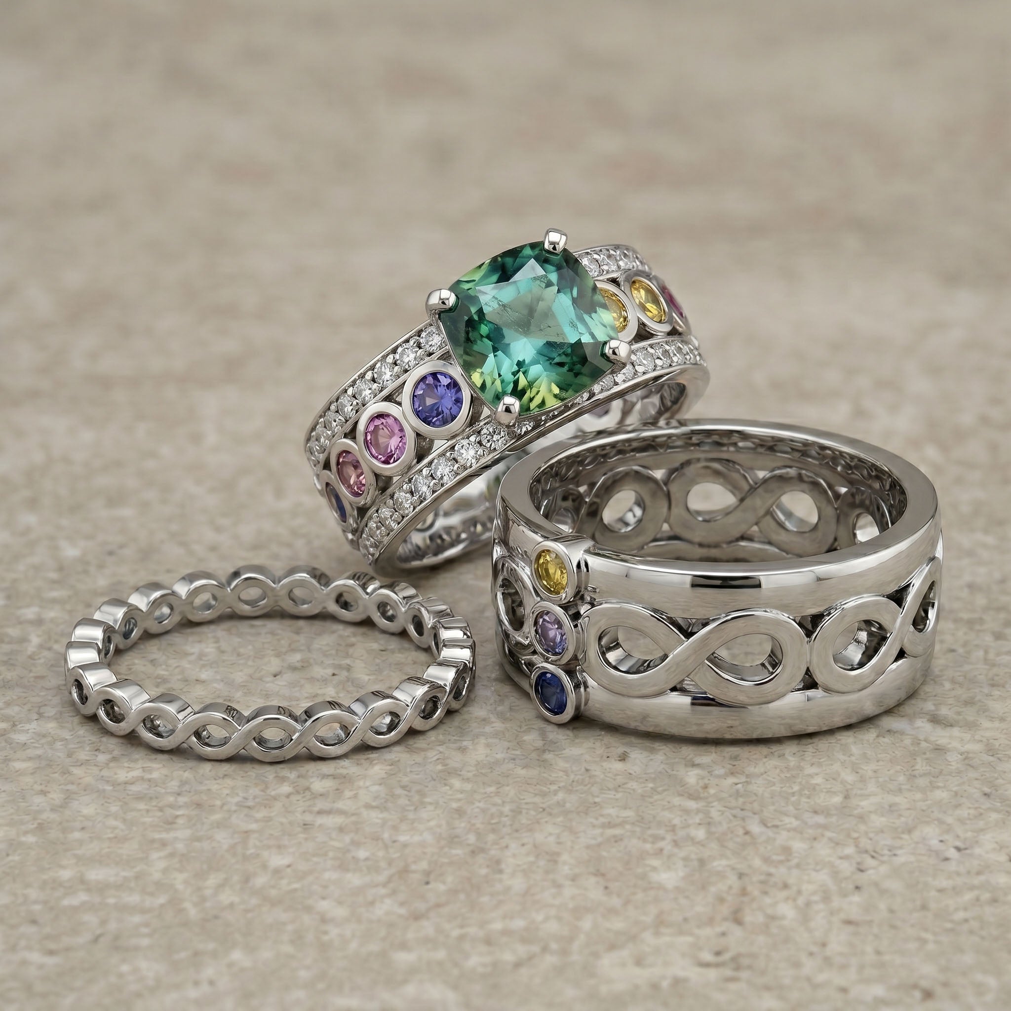 His and hers chakra themed engagment set with gemstones on a textured surface