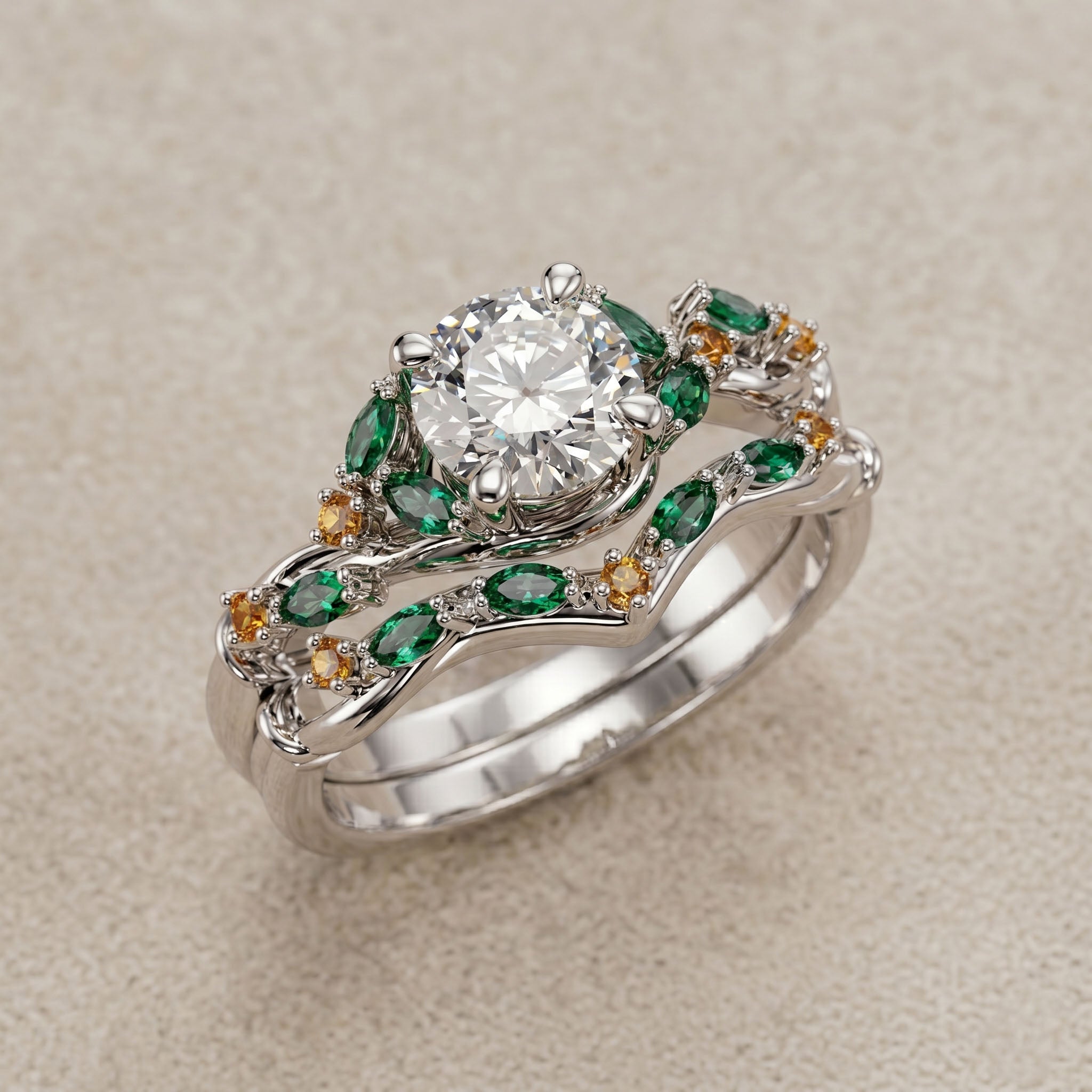 Silver ring with a large diamond and smaller green and orange gemstones on a beige background