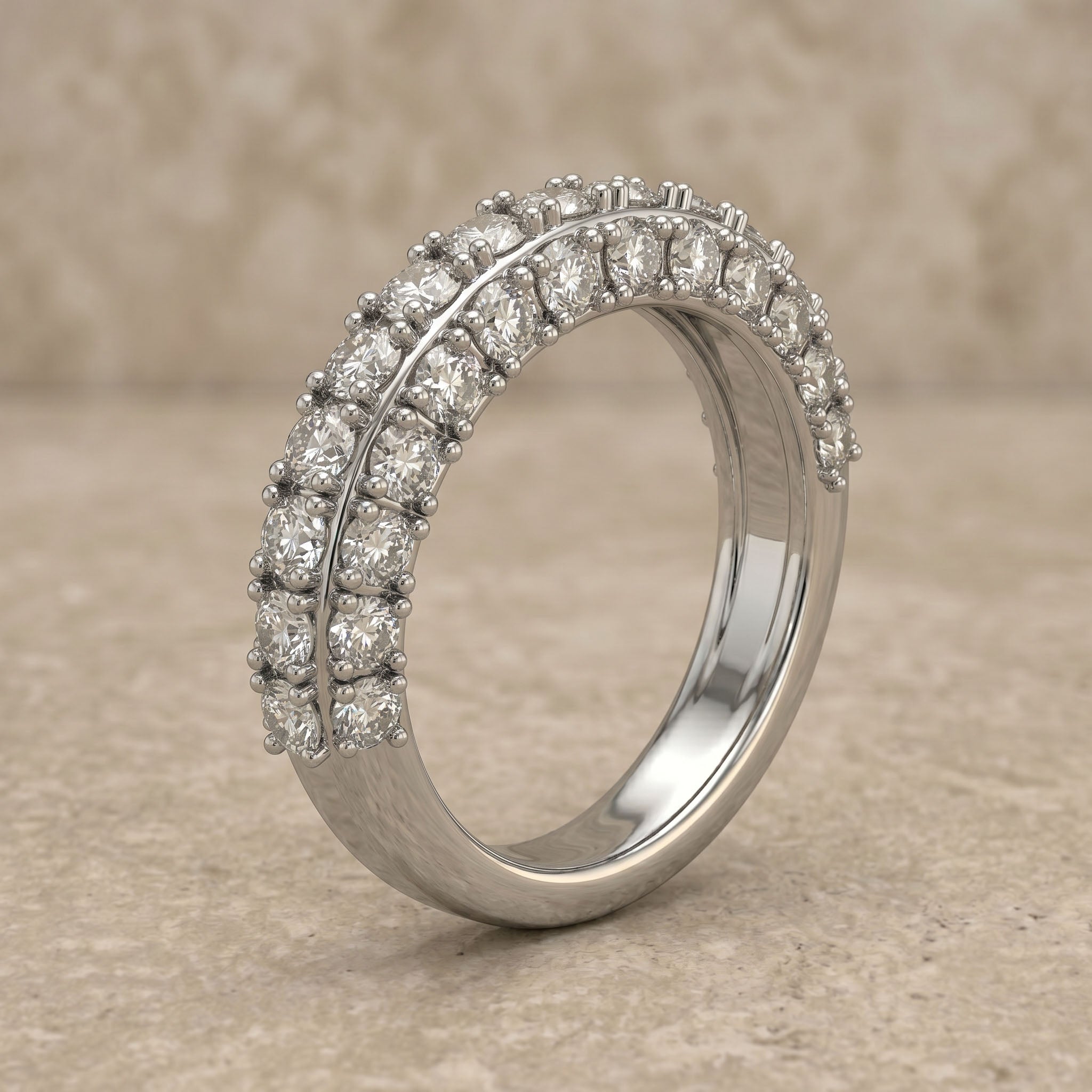 Silver ring with diamond accents on a beige background