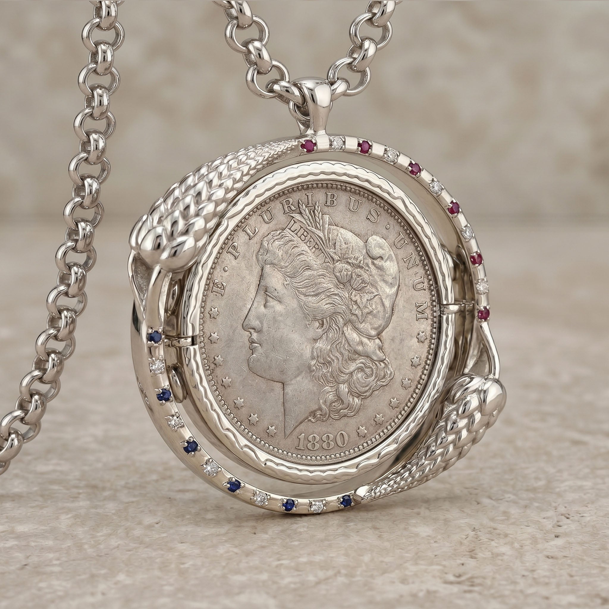 Silver pendant with a coin design on a neutral background