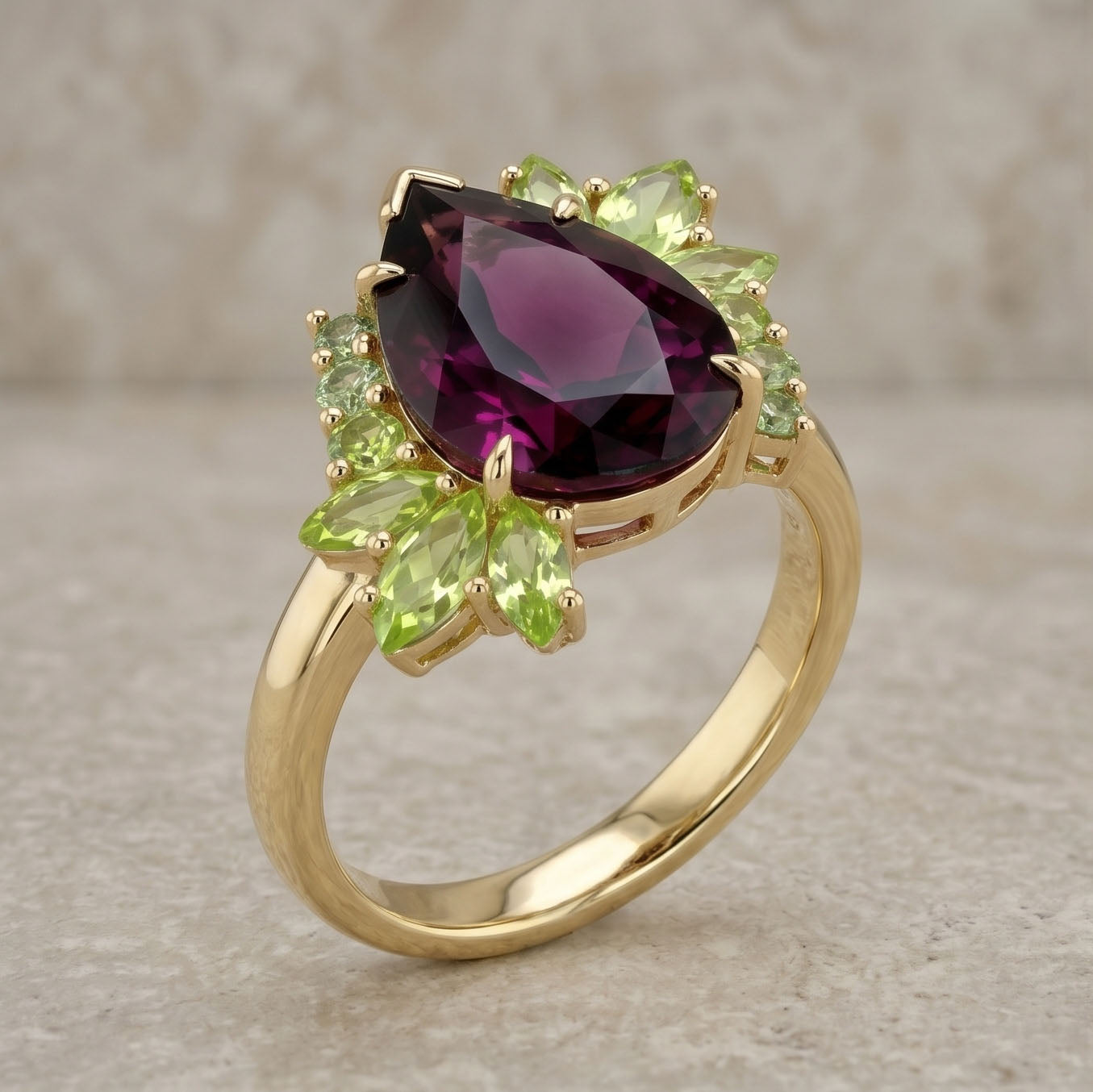 Gold ring with purple gemstone and green leaves on a beige background