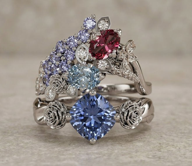 Multicolored gemstone ring with silver floral and leaf designs on a neutral background