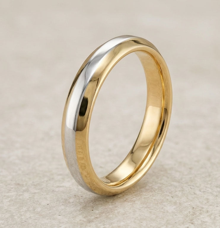 Two-tone gold ring on a textured beige background