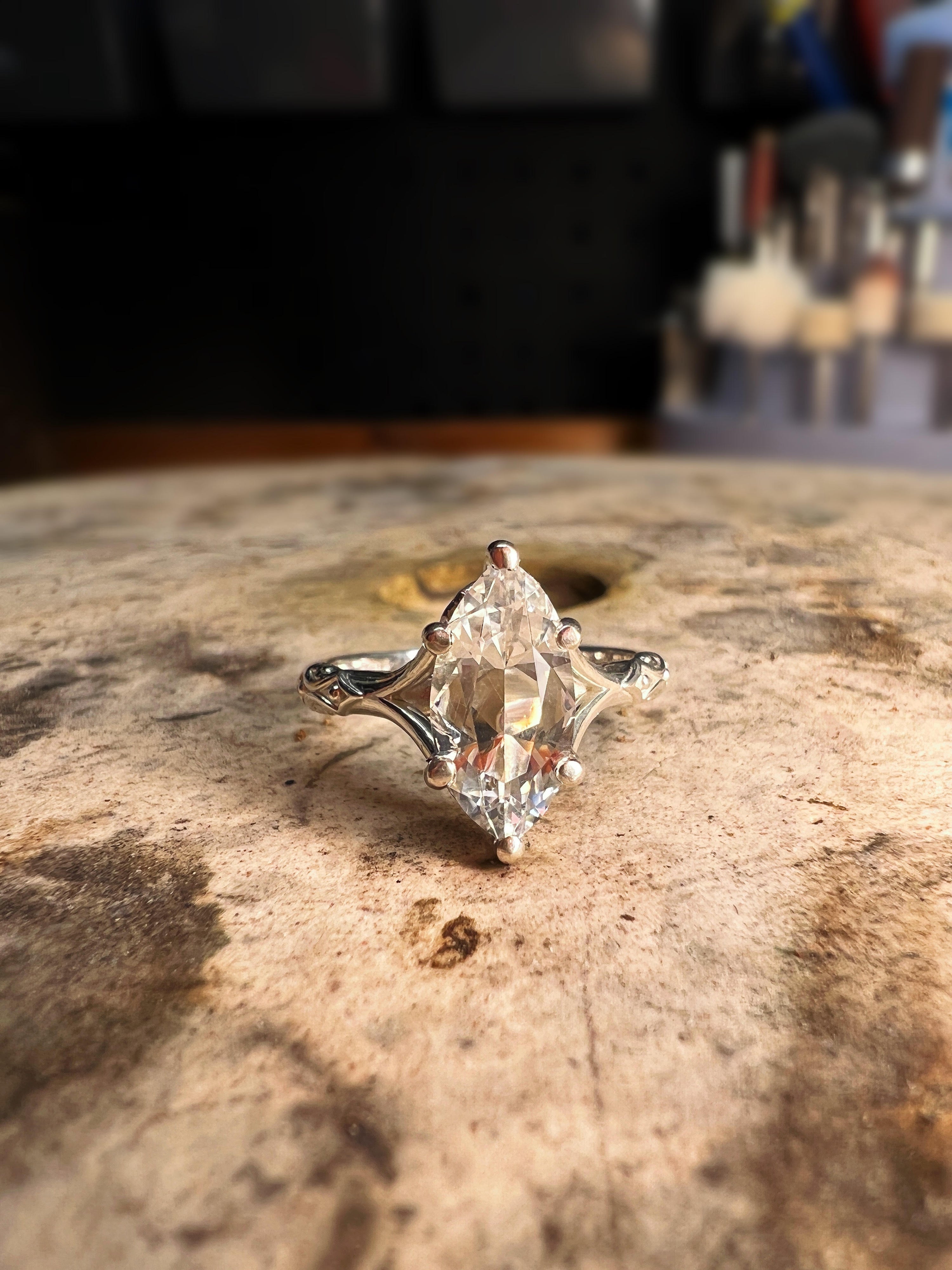 marquise engagement ring on jewelers bench